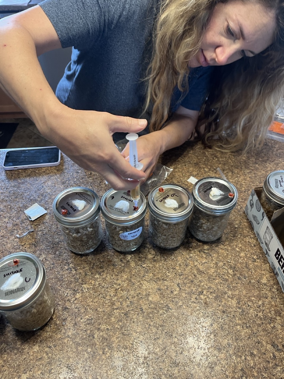 Inoculating mushroom spawn jars with spore syringe